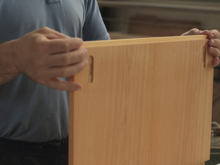 Lavorazione artigianale di un elemento in legno nel laboratorio Baistrocchi